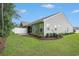 View of the home's green backyard, white fence, and screened in patio area at 2016 Willow Run Dr. # B, Little River, SC 29566