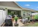 Charming patio area with outdoor seating, lush plants, barbecue grill, and a view of the well-maintained backyard at 2016 Willow Run Dr. # B, Little River, SC 29566