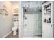 Modern bathroom with glass enclosed shower, white cabinetry and shelving for storage and organization at 2016 Willow Run Dr. # B, Little River, SC 29566