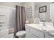 Well-lit bathroom featuring a shower/tub, toilet, vanity, and decorative beach-themed accessories at 2016 Willow Run Dr. # B, Little River, SC 29566