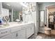 Bathroom with double sinks, white cabinets, and an adjacent walk-in closet for added convenience at 2016 Willow Run Dr. # B, Little River, SC 29566