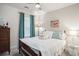 Bright bedroom featuring a full-size bed, ceiling fan, window with teal curtains, and decorative flamingo artwork at 2016 Willow Run Dr. # B, Little River, SC 29566