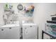 Functional laundry room with a washer, dryer, storage shelves and containers for laundry supplies at 2016 Willow Run Dr. # B, Little River, SC 29566