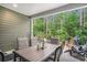 Relaxing covered patio with a dining set, outdoor seating, and a view of the lush green backyard at 2016 Willow Run Dr. # B, Little River, SC 29566