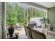 Inviting outdoor patio with a grill, dining set, lounge chairs, and serene backyard view for relaxed gatherings at 2016 Willow Run Dr. # B, Little River, SC 29566