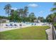 View of the community pool, with chairs, umbrellas, and cabana at 2016 Willow Run Dr. # B, Little River, SC 29566