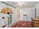 Bedroom featuring a ceiling fan, climbing vines, a red patterned rug, and view into an adjoining room at 2059 Borgata Loop, Longs, SC 29568