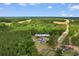 Aerial view showcasing the property at 2096 Golden Leaf Rd, surrounded by lush greenery and fields at 2096 Golden Leaf Rd., Galivants Ferry, SC 29544