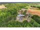 An aerial view of the property at 2096 Golden Leaf Rd, nestled amidst trees and open fields at 2096 Golden Leaf Rd., Galivants Ferry, SC 29544
