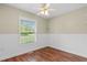 Cozy bedroom featuring a ceiling fan, a window, and wood-look flooring at 2096 Golden Leaf Rd., Galivants Ferry, SC 29544