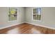 Bright bedroom featuring two windows and wood-look flooring at 2096 Golden Leaf Rd., Galivants Ferry, SC 29544