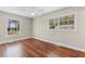 Bedroom featuring beautiful wood floors, light-colored walls, and two windows for ample natural light at 2096 Golden Leaf Rd., Galivants Ferry, SC 29544