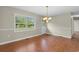 Bright dining room with wood floors, a large window, and a modern chandelier at 2096 Golden Leaf Rd., Galivants Ferry, SC 29544
