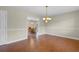 Inviting dining area with wood floors and a view into another dining space with wood table and chairs at 2096 Golden Leaf Rd., Galivants Ferry, SC 29544