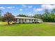 Well-maintained single-story home features brick accents, metal roof and manicured front lawn at 2096 Golden Leaf Rd., Galivants Ferry, SC 29544