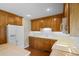 Traditional kitchen with wood cabinets, white appliances and hardwood floors at 2096 Golden Leaf Rd., Galivants Ferry, SC 29544