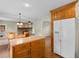 Traditional kitchen with white appliances and wood cabinets, open to the dining area at 2096 Golden Leaf Rd., Galivants Ferry, SC 29544