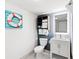 Bright bathroom featuring a white vanity, toilet, and nautical-themed decorations at 2301 S Ocean Blvd. # 621, Myrtle Beach, SC 29577