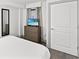 Bright bedroom showcasing a dresser with a TV and minimalist decor at 2301 S Ocean Blvd. # 621, Myrtle Beach, SC 29577
