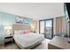 Bright bedroom with ocean view balcony, coastal decor, and a comfy chair at 2301 S Ocean Blvd. # 621, Myrtle Beach, SC 29577
