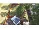 Aerial view of backyard with a wooden fence, green grass, mature trees, and a storage shed at 2519 Reta St., Conway, SC 29526