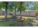 Serene backyard featuring mature trees, wood fence, patio with picnic table, and a well-maintained lawn at 2519 Reta St., Conway, SC 29526