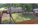 Well-maintained backyard featuring green grass, mature trees, wood fence, and patio space at 2519 Reta St., Conway, SC 29526