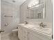 Bright bathroom with double sink vanity, modern lighting, and marble-look tiled flooring at 2519 Reta St., Conway, SC 29526