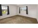 Empty bedroom with neutral carpet, two large windows, and natural light at 2519 Reta St., Conway, SC 29526