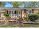 Charming brick home with white porch railing, and red shutters, offering inviting curb appeal at 2519 Reta St., Conway, SC 29526
