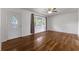 Well-lit living room showcasing hardwood floors, a ceiling fan, and front door access at 2519 Reta St., Conway, SC 29526