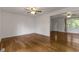 A bright living room with hardwood floors, a ceiling fan, and ample natural light at 2519 Reta St., Conway, SC 29526