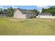 Backyard with a well-maintained lawn, grill, patio set and mature trees at 2521 Wise Rd., Conway, SC 29526