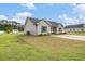 Beautiful exterior view of the home showcasing the lawn, siding, and storage shed in the backyard at 2521 Wise Rd., Conway, SC 29526