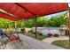 Enjoy the backyard from this deck with red awning, a swing and a grill, and potted plants at 2650 Highway 554, Loris, SC 29569