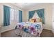 Bedroom features flower-patterned bedding, with natural light streaming through the window with curtains at 2710 South Ocean Blvd. # 208, Myrtle Beach, SC 29577