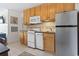 Galanz stainless steel refrigerator in kitchen with wood cabinets at 2710 South Ocean Blvd. # 208, Myrtle Beach, SC 29577