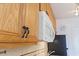 Close up of kitchen cabinet with seahorse handles and white microwave in modern kitchen at 2710 South Ocean Blvd. # 208, Myrtle Beach, SC 29577