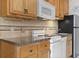This kitchen features modern white appliances and tile backsplash at 2710 South Ocean Blvd. # 208, Myrtle Beach, SC 29577