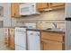 This well-lit kitchen features modern appliances and wood cabinets at 2710 South Ocean Blvd. # 208, Myrtle Beach, SC 29577