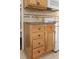 Kitchen featuring oak cabinets, backsplash, and white oven, with a glimpse into the bathroom at 2710 South Ocean Blvd. # 208, Myrtle Beach, SC 29577