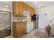 Efficient kitchen features wood cabinets, tile backsplash, and white appliances at 2710 South Ocean Blvd. # 208, Myrtle Beach, SC 29577