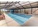 Indoor pool area featuring clear skylight roofing, benches, and clear blue water at 2710 South Ocean Blvd. # 208, Myrtle Beach, SC 29577