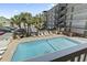 Inviting swimming pool area surrounded by palm trees, providing a relaxing vacation atmosphere at 2710 South Ocean Blvd. # 208, Myrtle Beach, SC 29577