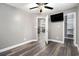 Bedroom featuring a ceiling fan, TV, closet, and wood-look flooring throughout at 299 Lake Arrowhead Rd., Myrtle Beach, SC 29572