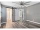 Bedroom featuring a sliding barn door and wood-look flooring throughout at 299 Lake Arrowhead Rd., Myrtle Beach, SC 29572