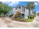 Charming home with a wooden staircase leading to the front porch, complemented by lush landscaping at 299 Lake Arrowhead Rd., Myrtle Beach, SC 29572