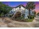Charming home with a wooden staircase leading to the front porch, complemented by lush landscaping at 299 Lake Arrowhead Rd., Myrtle Beach, SC 29572