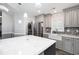 Bright, modern kitchen with white quartz counters, stainless steel appliances, and adjacent laundry area at 299 Lake Arrowhead Rd., Myrtle Beach, SC 29572