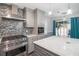 Open kitchen with stainless steel appliances, mosaic backsplash, and a large island with quartz countertop at 299 Lake Arrowhead Rd., Myrtle Beach, SC 29572